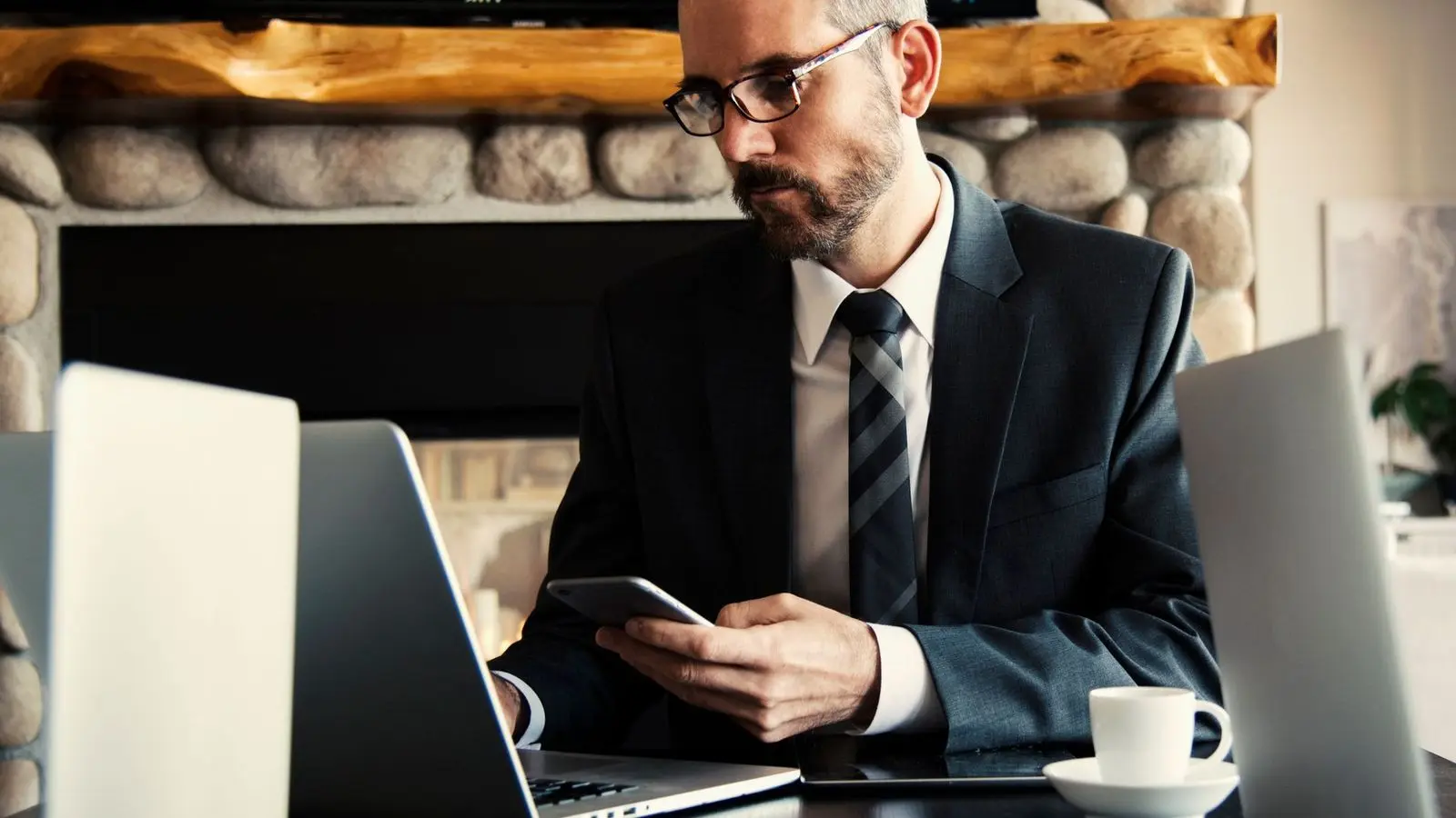 A lawyer in a suit working on a laptop at a desk