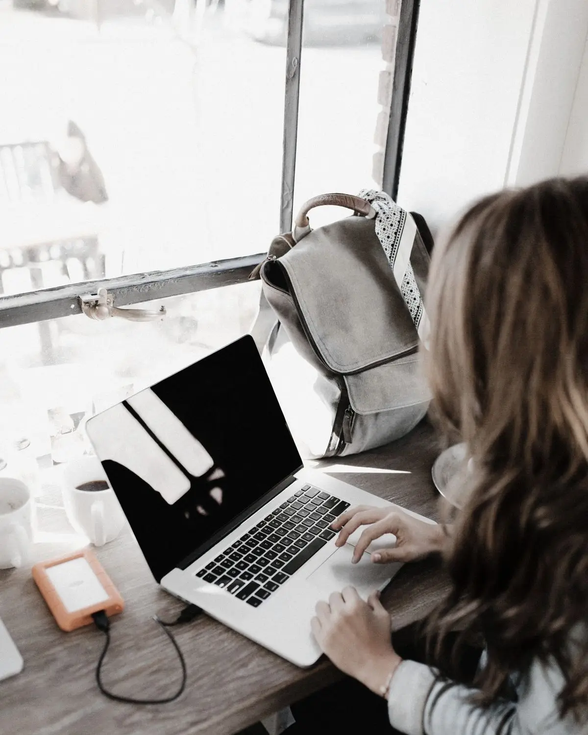 A client checking her case file on a laptop